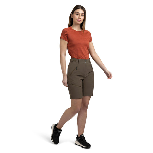 Woman wearing a red shirt and brown shorts on a white background