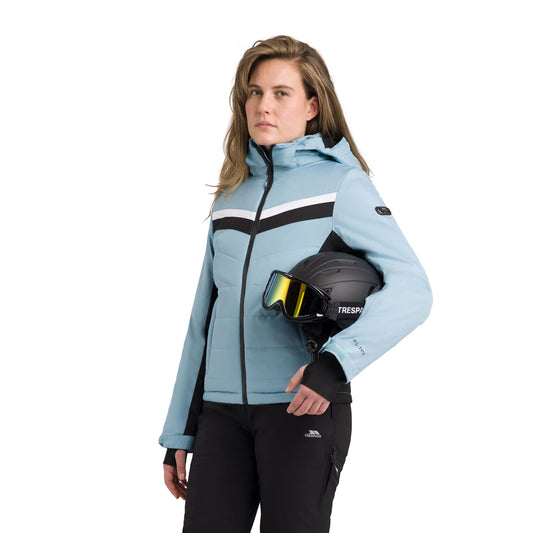 Woman wearing a light blue Ski jacket Emma holding a Ski helmet with a white background