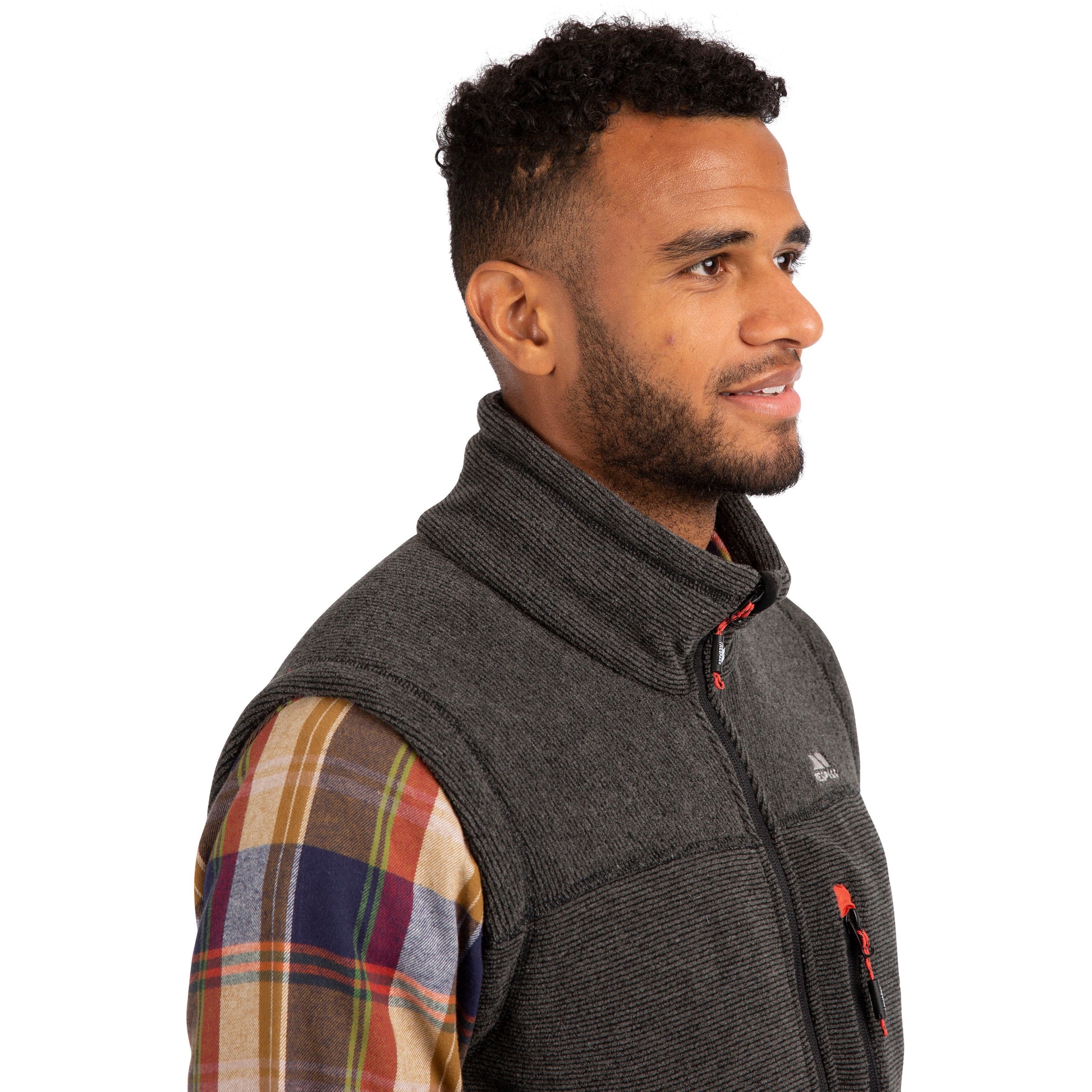 side view of man wearing grey and black heavyweight trespass fleece gilet