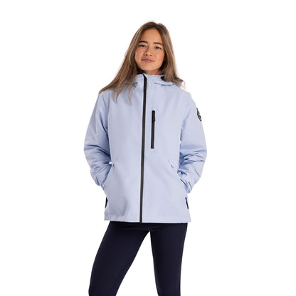 Woman wearing a light blue jacket with black accents on a white background