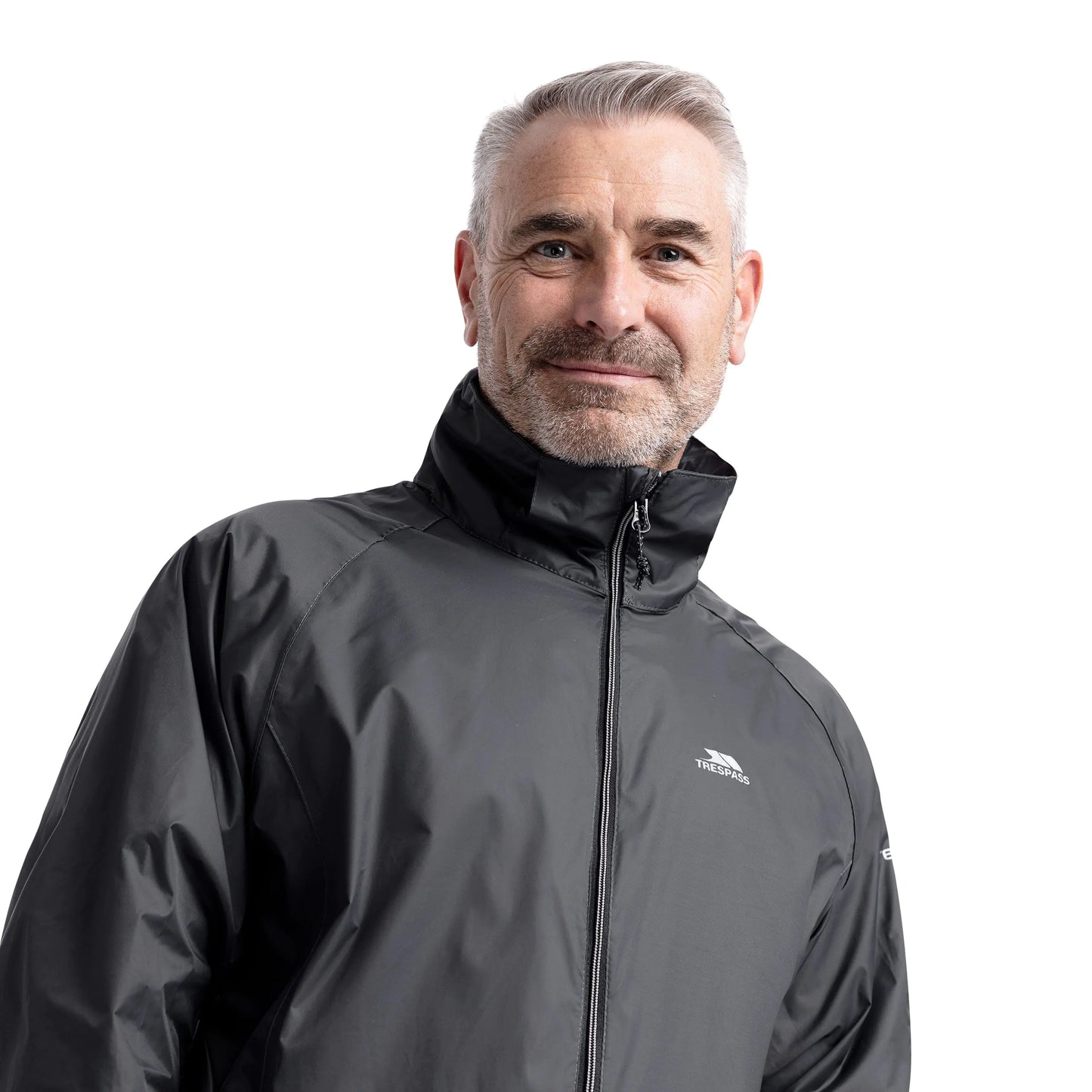 Man wearing a Flint grey Qikpac jacket with a Trespass brand logo on a white background