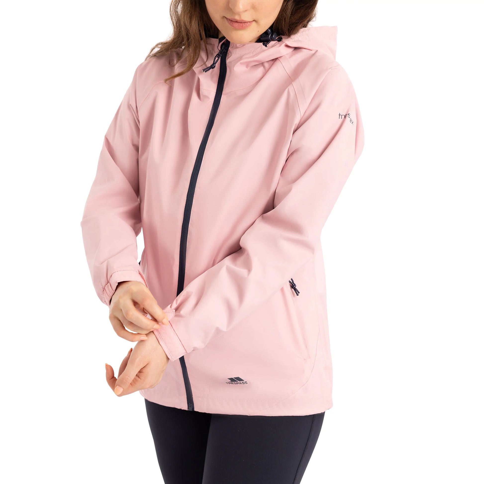 Woman wearing a pink tayah raincoat with a white background